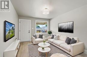 Hamilton (Mcquesten) apartment for rent - A living room with a white couch, a coffee table, and a painting on the wall.