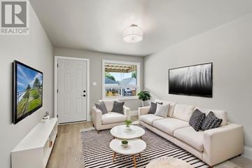 Hamilton (Mcquesten) apartment for rent - A living room with a white couch, a coffee table, and a painting on the wall.