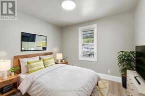 Hamilton (Mcquesten) apartment for rent - A bedroom with a bed, nightstands, and a window.