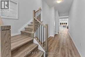 Pelham (Fonthill) apartment for rent - A hallway with wooden floors and a staircase with a wooden handrail.