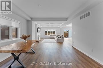 Pelham (Fonthill) apartment for rent - A spacious living room with a wooden table and white sofas.
