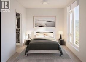 Coquitlam apartment for rent - A bedroom with a large bed and a painting on the wall.