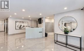 Toronto (Flemingdon Park) condo for rent - A realtor office with a white reception desk and a mirror on the wall.