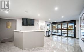 Toronto (Flemingdon Park) condo for rent - A realtor's office with a white reception desk and a flat screen TV mounted on the wall.