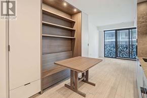 Toronto (Church-Yonge Corridor) condo for rent - A modern kitchen with a wooden table and cabinets.