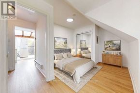 Toronto (The Beaches) apartment for rent - A bedroom with a bed, nightstand, and a dresser with a mirror above it.