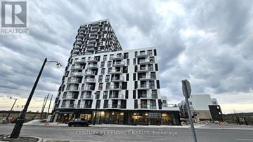 Oakville (Jm Joshua Meadows) condo for rent - A modern building with a glass facade is the main focus of the image.