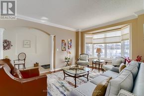 Milton (Be Beaty) apartment for rent - A living room with a brown leather couch, a grey sofa, a coffee table, and a large window with blinds.