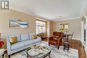 Milton (Be Beaty) apartment for rent - A living room with a grey couch, a glass coffee table, and a painting on the wall.