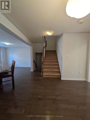 Cambridge townhouse for rent - A room with a wooden floor and a staircase.