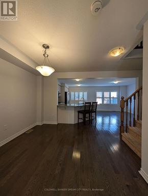 Cambridge townhouse for rent - A room with wooden floors and a staircase.