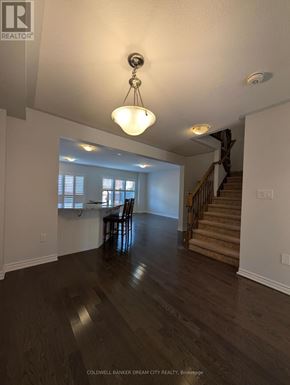 Cambridge townhouse for rent - A large open space with a wooden floor and a staircase.