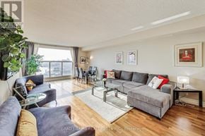 Toronto (Waterfront Communities) condo for rent - A living room with a grey couch and a glass table.