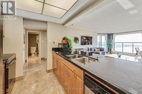 Toronto (Waterfront Communities) condo for rent - A modern kitchen with wooden cabinets and a large island.