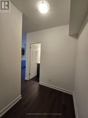 Toronto (Glenfield-Jane Heights) condo for rent - A hallway with wood floors and white walls.