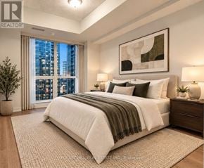 Toronto (Yonge-Eglinton) condo for rent - A well-lit bedroom with a large bed and a city view through the window.
