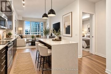 Toronto (Yonge-Eglinton) condo for rent - A modern kitchen with a dining area and a living room with a couch and a bed.