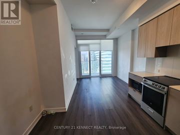 Mississauga (City Centre) condo for rent - A kitchen with wooden floors and a stove top oven.