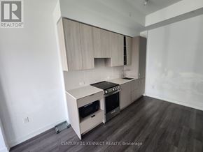 Mississauga (City Centre) condo for rent - A kitchen with a stove top oven and a microwave.