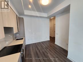 Mississauga (City Centre) condo for rent - A kitchen with wooden floors and white walls.