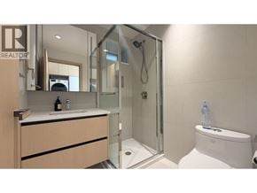 Vancouver apartment for rent - A modern bathroom with a walk-in shower and a toilet.