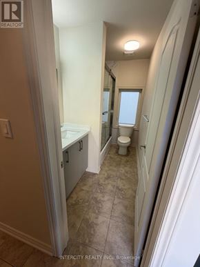 Toronto (Oakwood Village) apartment for rent - A bathroom with a toilet, sink, and mirror.
