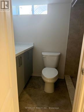 Toronto (Oakwood Village) apartment for rent - A white toilet in a small bathroom with a window.