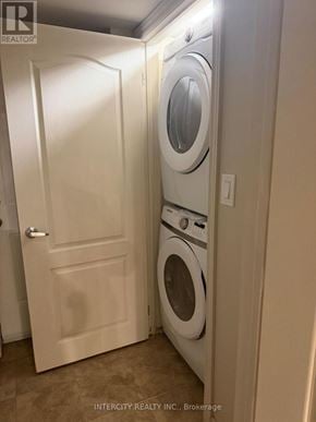 Toronto (Oakwood Village) apartment for rent - A white door is open to a small laundry room with a washer and dryer.