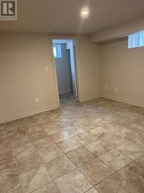 Toronto (Oakwood Village) apartment for rent - A room with tiled flooring and a doorway leading to another room.