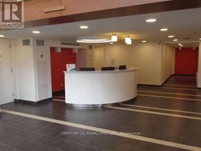 Toronto (Downsview-Roding-Cfb) condo for rent - A reception area with a white counter and a red wall.