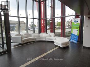 Toronto (Downsview-Roding-Cfb) condo for rent - A white couch is in front of a glass wall with a sign on the right side.