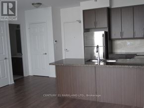 Toronto (Downsview-Roding-Cfb) condo for rent - A kitchen with a refrigerator, cabinets, and a countertop.