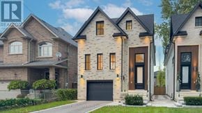 Mississauga (Port Credit) apartment for rent - A modern house with a large front yard and a garage.