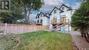 Mississauga (Port Credit) apartment for rent - A modern house with a white exterior and a wooden deck.