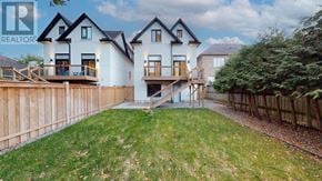Mississauga (Port Credit) apartment for rent - A large white house with a wooden fence in front.