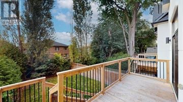 Mississauga (Port Credit) apartment for rent - A deck with a railing and a view of a backyard with a pool.