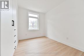 Toronto (Dovercourt-Wallace Emerson-Junction) townhouse for rent - A room with a window and a door with a handle.