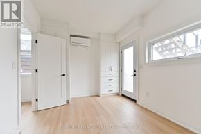 Toronto (Dovercourt-Wallace Emerson-Junction) townhouse for rent - A white room with a door, drawers, and a window.