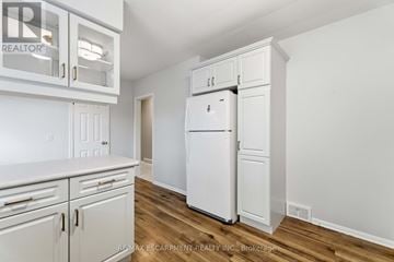 St. Catharines (Bunting/Linwell) apartment for rent - A white refrigerator is in a kitchen with white cabinets.