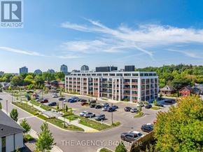 Guelph (St. Patrick's Ward) condo for rent - A large building with a parking lot in front of it.