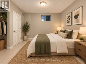Toronto (Ionview) condo for rent - A bedroom with a bed, nightstand, and a window.