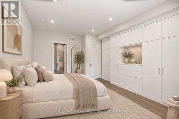 Toronto (High Park-Swansea) duplex for rent - A bedroom with a large bed and a painting on the wall.
