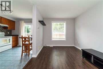 Stoney Creek townhouse for rent - A kitchen with a wooden chair and a window.