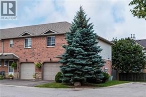 Stoney Creek townhouse for rent - A house with a large tree in front of it.
