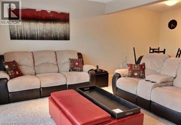 Kitchener townhouse for rent - A living room with a white couch and a red ottoman.