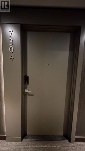 Mississauga (City Centre) condo for rent - A door with the number 7303 on it is closed.