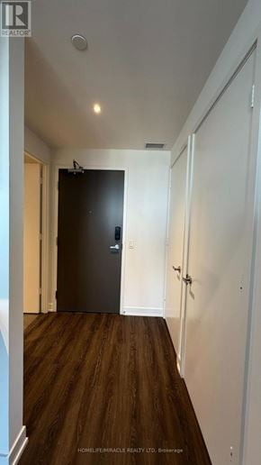 Mississauga (City Centre) condo for rent - A hallway with a black door and wooden floors.
