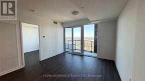 Mississauga (City Centre) condo for rent - A room with a view of the beach through large windows.