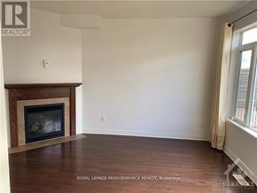 Ottawa apartment for rent - A room with a fireplace and wooden floors.