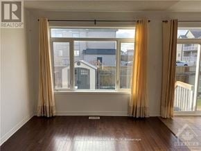 Ottawa apartment for rent - A room with a large window and curtains.